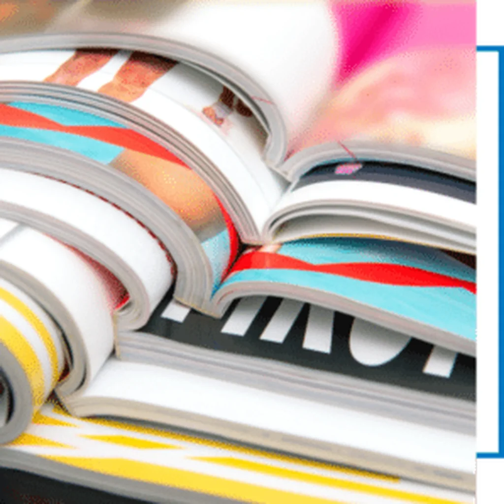 Gestapelde kleurrijke handleidingen of instructieboeken met gelijmde rug en glanzende afwerking.